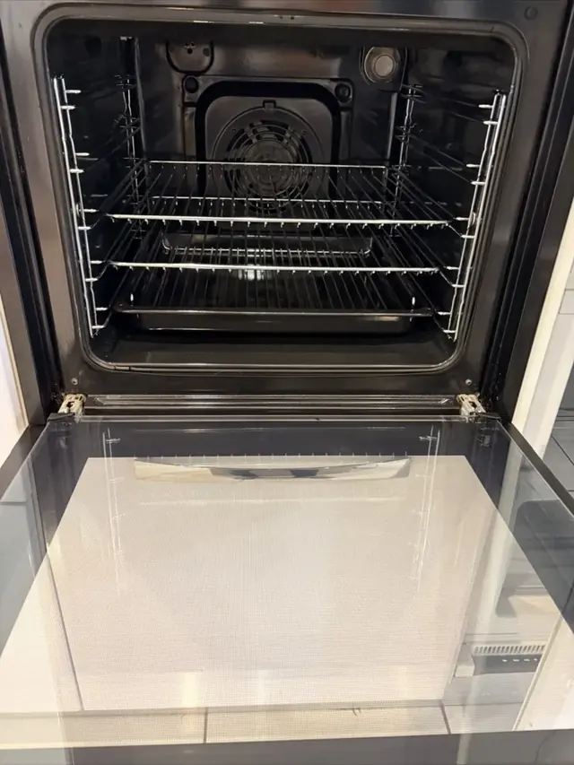 The same oven base cleaned back to bare enamel after professional oven cleaning