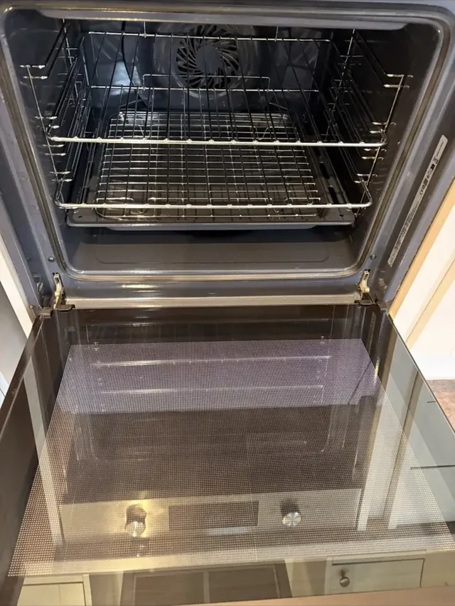 Clear oven door glass and clean base after professional cleaning
